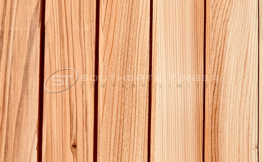 Close-up view of Western Red Cedar cladding boards showing natural reddish-brown tones and vertical grain pattern, supplied by Southgate Timber for high-quality exterior cladding